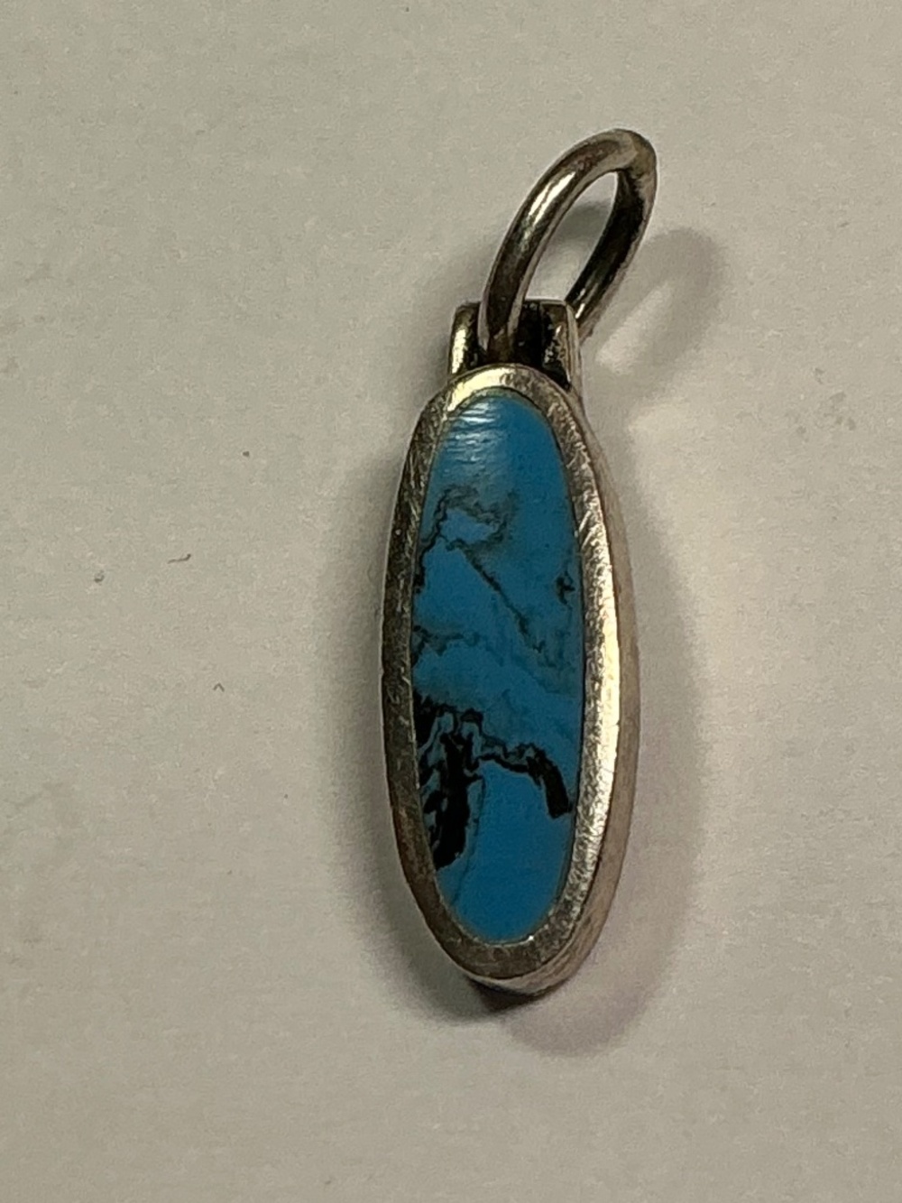 Sterling Silver Oval Shaped Pendant / Charm with a Blue Stone. 7/8” long